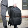 Backpack Hogan negra impermeable de poliéster con compartimento para laptop y tres bolsos frontales para sector TI. Uso en mano.
