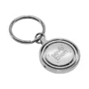 Llavero Terra circular de metal con superficie interior giratoria y estuche de regalo individual.