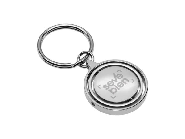 Llavero Terra circular de metal con superficie interior giratoria y estuche de regalo individual.