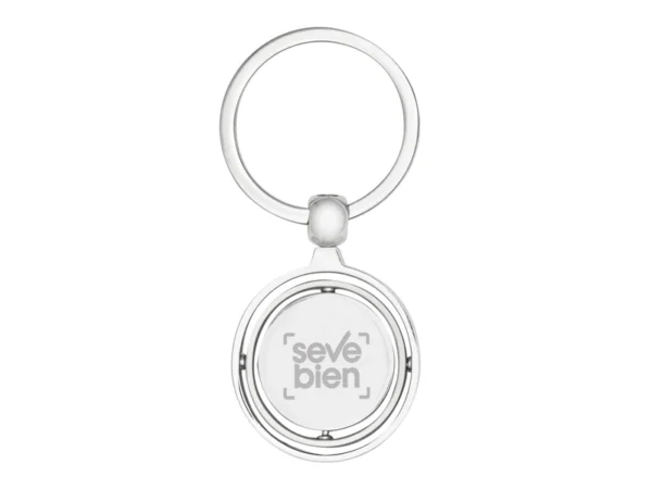 Llavero Terra circular de metal con superficie interior giratoria y estuche de regalo individual.