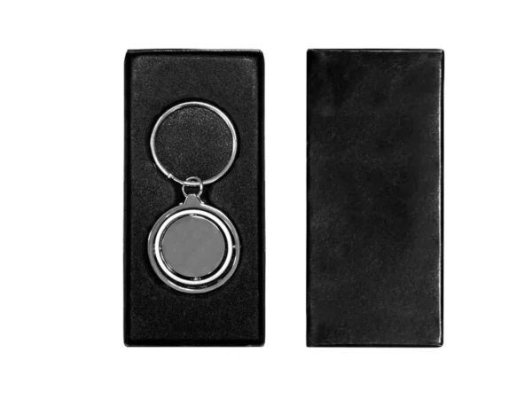 Llavero Terra circular de metal con superficie interior giratoria y estuche de regalo individual.