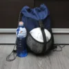 Mochila Loshside de poliéster con compartimento frontal de malla para balón, color azul y negro